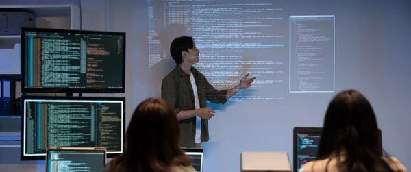 asian man presents code using 600nw 2638995453